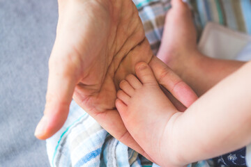 Baby and newborn concept: Mother’s hands holding newborn baby feet