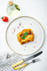 Italian Food. Hot Tasty Freshly Baked Lasagna, on plate, on white stone  background, top view, flat...