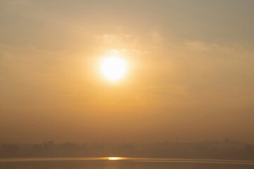 Stock photo of Beautiful calm and golden sunset scene, sunlight reflected in lake water. Picture captured during summer vacation at Kolhapur city Maharashtra India