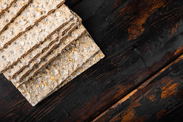 Low calories snack bread, on old dark  wooden table background, top view flat lay, with copy space...