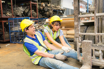 Accident of working man in medium shot, forklift over leg of engineer. Asian engineer worker man was crushed by a forklift and engineer woman helping him in factory shot, forklift over leg of engineer