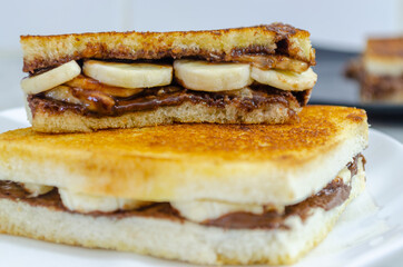 Yummy Chocolate Banana Sandwich cut into half on top of another. Macro shot.