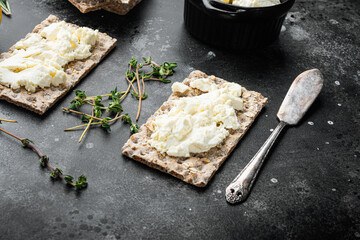 Homemade Crisp bread toast with Cottage Cheese, on black dark stone table background, with copy...