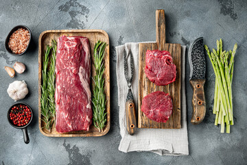 Tenderloin, or Eye Fillet cut raw marbled beef meat, on gray stone background, top view flat lay