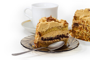 Piece of sponge cake on saucer against cup, close-up
