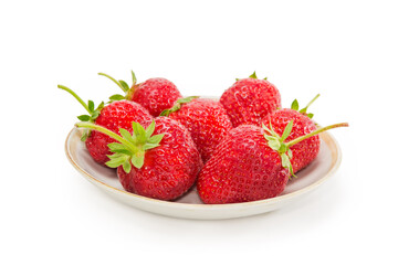Strawberries with tails on saucer on white background, close-up
