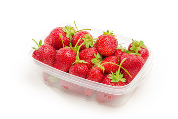 Freshly harvested strawberries in food container on a white background