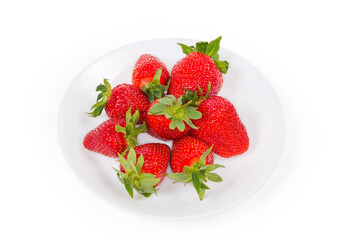 Fresh strawberries with tails on dish on a white background