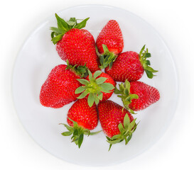 Top view of fresh strawberries with tails on white dish