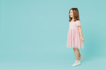 Full size body length little fun cute kid girl 5-6 years old wears pink dress dancing isolated on pastel blue color background child studio portrait. Mother's Day love family people lifestyle concept.