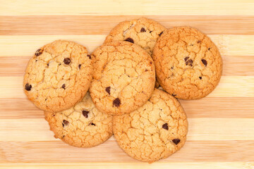 Chocolate chip cookies on bamboo wooden surface, top view