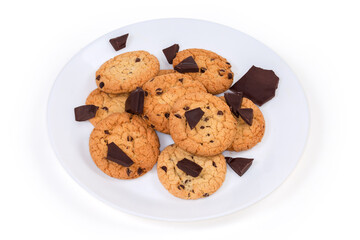 Chocolate chip cookies and broken chocolate pieces on white dish