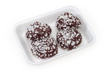 Chocolate-coated zefir on foam food tray on white background