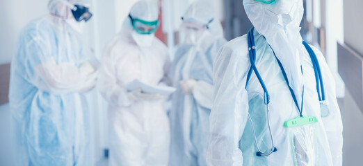 Doctors team in protective suits and masks in control red area covid 19. Concept medical protective...