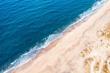 Beach and blue water waves seascape background from aerial top view. Concept travel and vacation summer nobody