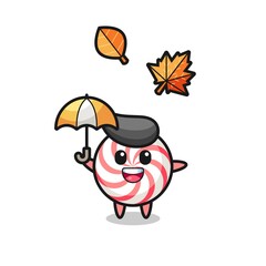 cartoon of the cute candy holding an umbrella in autumn