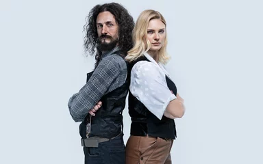 Poster Funny hipster couple posing on white background © konradbak