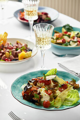 Beautifully decorated catering banquet table with different food snacks and appetizers. Isolated on white backgraund