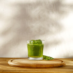 Fresh green drink on wooden desk and wall background 