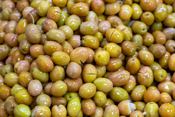 Scratched green olives. Close up. Green olives as background texture