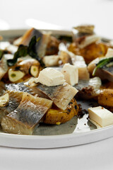 Salted herring with potatoes and onions close-up, an appetizing plate with a classic Russian appetizer