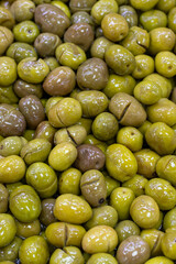 Scratched green olives. Close up. Green olives as background texture
