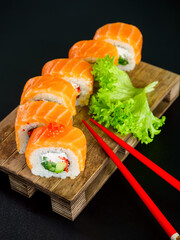 uramaki sushi roll with salmon, avocado, cream cheese philadelphia