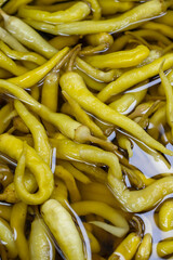 Pickled peppers. Close up. Pepper pickles as background texture