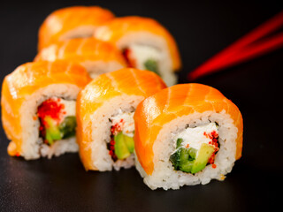 uramaki sushi roll with salmon, avocado, cream cheese philadelphia