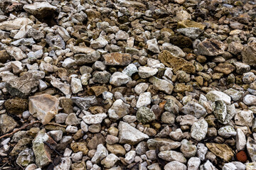 The texture of stones with jagged edges. Lots of small stones.