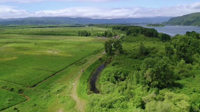 Scenic View Of Columbia River And Farmland In Portland, Oregon At Springtime. aerial drone