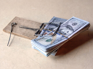 An American hundred-dollar bill in bundles in a mousetrap. A financial trap.          