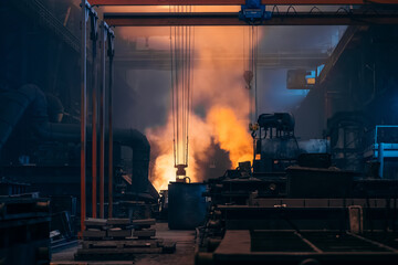 Metallurgical production factory, foundry workshop interior, bright smoke from blast furnace, heavy...