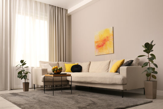 Stylish living room interior with modern comfortable sofa