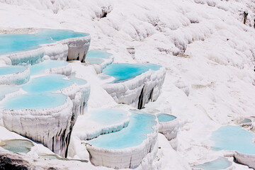 Pamukkale Turkey, calcium cascade terraces of white stalactites. Beautiful landscape nature background. Cotton castle in southwestern Turkey.