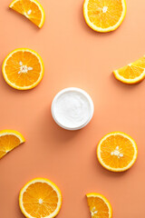 Vitamin C moisturizer cream with slices orange Flat lay, top view. Natural organic product, beauty and spa concept