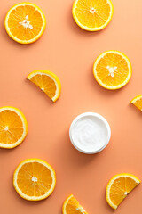 Vitamin C moisturizer cream with slices orange Flat lay, top view. Natural organic product, beauty and spa concept