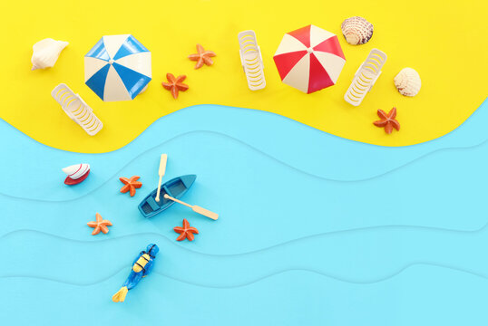 holidays top view image of tropical sea and beach chairs under umbrellas. Summer travel and vacation concept