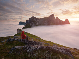 A tourist enjoying a view at the Mountain Hesten, Senja, Norway. Trekking in Norway, active life concept