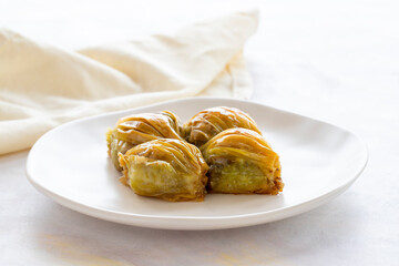 Mussels baklava Turkish pistachio baklava on a white background. Local name midye baklava