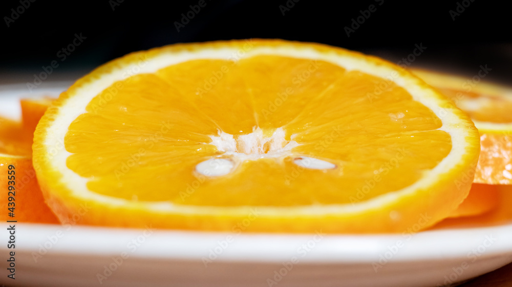 Wall mural sliced orange slices on a plate, citrus fruits