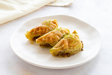 Turkish Dessert Sobiyet Baklava. Turkish pistachio baklava on a white background. Local name şöbiyet baklava