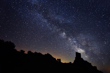 Fototapeta premium the milky way and the stars next to a castle