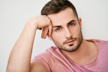Closeup portrait of handsome sexy man looking at camera on white background