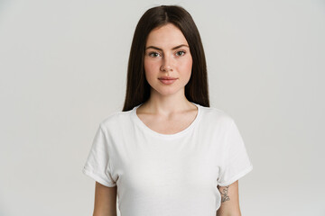 Fototapeta premium Young brunette woman posing and looking at camera