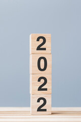 2022 wooden cube blocks on table background. Resolution, plan, review, goal, start and New Year holiday concepts