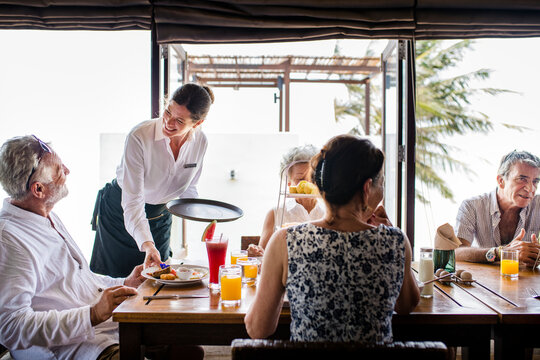 Friends Having Breakfast At A Hotel