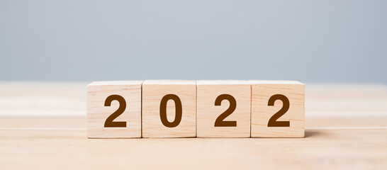 2022 wooden cube blocks on table background. Resolution, plan, review, goal, start and New Year...