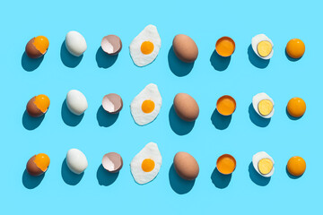 Flat Lay Composition with eggs cooked in different ways on blue background.