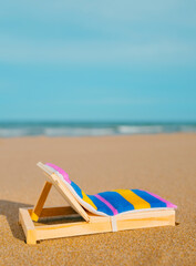 Fototapeta premium miniature deck chair on the beach